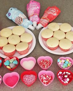 valentine's day cupcakes on plates with candy hearts