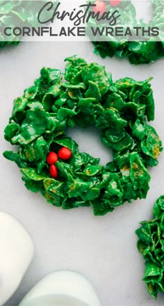 green frosted christmas wreath cookies sitting on top of a table