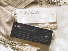 a gift certificate sitting on top of a table next to some dried plants and cloth