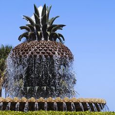 a large pineapple fountain with water spouting from it