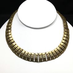 *Description: This is a great vintage link metal choker necklace, made in a book chain style, with a hint of vermeil, when tested, from the 1930s or before. The necklace is 16 inches in length and closes with a wide alligator clasp. This would be a great addition to your vintage jewelry collection or make a great vintage gift! *Approximate Measurements: Length - 16 Inches, Width - 5/8 Inch, Total Weight - 1.5 Ounces *Condition: Great vintage condition. Will see signs of wear under magnification. Vintage Gold-tone Brass Necklace, Vintage Jewelry With Box Chain Link, Vintage Box Chain Necklace, Retro Yellow Gold Necklace For Formal Occasions, Formal Brass Choker, Vintage Gold-tone Metal Chain Necklace, Vintage Brass Choker Jewelry, Vintage Metal Choker For Formal Occasions, Gold Retro Choker