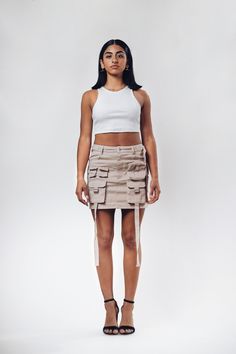 Get ready to amp up your streetwear game with our freshest creation - introducing the ACS Mini Cargo Skirt! We've poured our techwear and streetwear passion into this beauty, and we can't wait for you to experience it firsthand. *Intricate Design, Striking Look: Dive into the dynamic front design, featuring cargo pockets and hanging straps. This combination crafts a unique silhouette that effortlessly catches attention, making each step a statement. *Beige Colorway: Elevate your wardrobe with th Fitted Denim Mini Skirt For Streetwear, Fitted Short Mini Skirt For Streetwear, Y2k Style Skort For Streetwear In Spring, Y2k Mini Skirt For Streetwear, Streetwear Mini Skort With Pockets, High Waist Cargo Skirt For Summer Streetwear, High Waist Summer Skort For Streetwear, Fitted Streetwear Skirt With Pockets, Y2k Style Cargo Skirt For Spring Streetwear