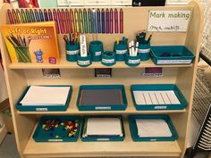 there are many different items on the shelf in this classroom room, including markers, pencils, and other school supplies