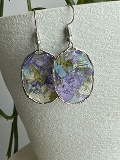 Cute resin earrings in a silver color metal bezel frame. purple flower confetti. Bezel is about 1" long and earring hangs 2". No two earrings are exact as they are made with real flowers. Handmade Metal Flower Earrings For Summer, Silver Round Resin Earrings, Silver Flower Earrings For Summer, Elegant Purple Jewelry For Summer, Elegant Purple Summer Jewelry, Elegant Summer Purple Jewelry, Nickel-free Silver Resin Jewelry, Summer Flower Earrings In Sterling Silver For Gift, Summer Flower Sterling Silver Earrings For Gift