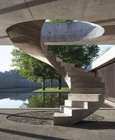 a concrete staircase next to a body of water