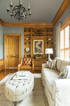 a living room filled with furniture and a chandelier