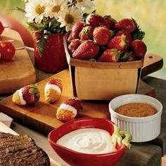 some strawberries and other foods on a table