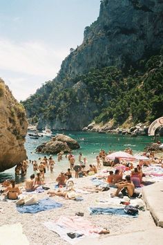 many people are on the beach and in the water