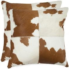 a brown and white cowhide pillow on a white background