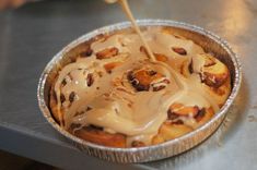 a pan filled with cinnamon rolls covered in icing