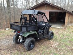 a utility vehicle parked in front of a barn