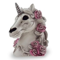 a white unicorn skull with pink roses on it's head is shown in front of a white background