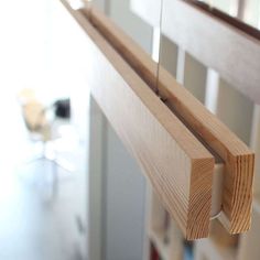 a close up view of a wooden shelf in a room with bookshelves and chairs