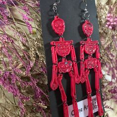 These are handmade resin skeleton earrings in opaque red with glitter. dangles 5 inches. Shipping cost included in featured price no international shipping Red Resin Novelty Earrings, Red Resin Novelty Jewelry, Novelty Red Resin Jewelry, Red Plastic Party Jewelry, Red Plastic Earrings For Gift, Red Pierced Halloween Earrings, Red Pierced Earrings For Halloween, Red Earrings As Halloween Gift, Red Earrings For Halloween Gift