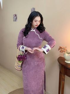 Featuring a rich textured fabric in a deep, luxurious plum shade, the Lizi 李子 Plum 1920s Inspired Qipao is the perfect combination of historical silhouette and modern touches. The long sleeves and heavier fabric make this a great choice for colder weather, while the scallop trim front panel adds a touch of delicate femininity. The standout feature of this qipao is its intricately embroidered cuffs, adorned with exquisite purple floral designs that bring a pop of color and artistry to the overall Purple Qipao, Purple Hanfu, Hanfu Men, Embroidered Cuffs, Modern Hanfu, Scallop Trim, New Chinese Style, Chinese Clothing, Textured Fabric