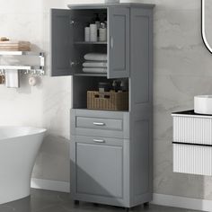 a bathroom with a sink, toilet and cabinet in it's corner next to the bathtub