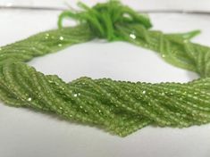 a close up of a green bracelet on a table