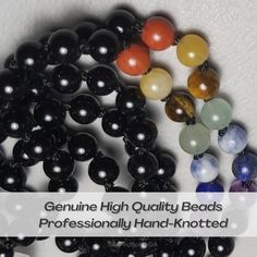 Black Onyx 7 Chakra High Quality Gemstone Meditation Mala with White Quartz Guru Bead: Amethyst, Lapis Lazuli, Sodalite, Green Aventurine, Tiger's Eye, Yellow Calcite, Red Jasper. 🙌 Metaphysical Properties 🙌 Total Energy Vibration Alignment.  Amethyst ~ Spiritual Healing and Wisdom  Lapis Lazuli ~ Strength, Courage, Intellect and Truth Sodalite ~ Clear Logical Thinking and Discipline  Green Aventurine ~ Abundance, Wealth, Good Fortune  Tiger Eye ~ Personal Power, Self Confidence and Courage  Yellow Calcite ~ Mental Clarity, Analysis, Discernment and Memory  Red Jasper ~ Grounding, Protection, Inner-Strength, Endurance, Balance  Black Onyx ~ Protection, Focus, Intuition, and Balance. Each bead is indivually inspected for surface irregularities, intuitively placed to provide flow and balan Black Hand-knotted Jewelry With Round Beads, Spiritual Black Beads Mala For Meditation, Handmade Black Mala For Meditation, Adjustable Black Spiritual Mala, Black Hand-strung Mala For Meditation, Black Faceted Spiritual Beads, Mala Meditation, Meditation Mantras, Yellow Calcite