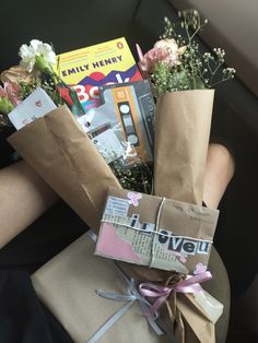 the flowers are wrapped in brown paper and tied with pink ribbon, sitting on a car seat