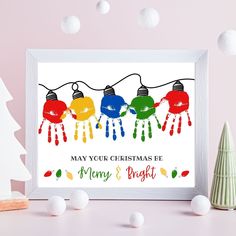 a christmas card with colorful lights hanging from it