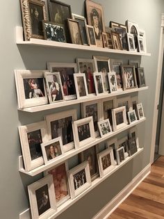 a wall filled with pictures and framed photos