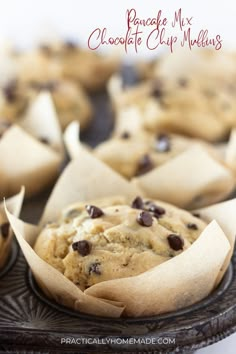 chocolate chip muffins on a plate with paper wrappers