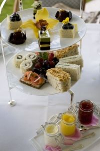 the table is set with bread, jams and croissants