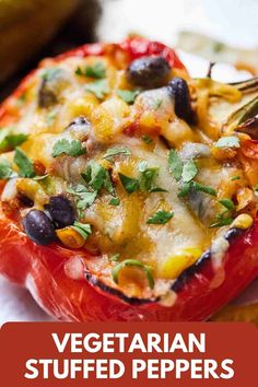 vegetarian stuffed peppers with black olives and cilantro on the side in a white plate