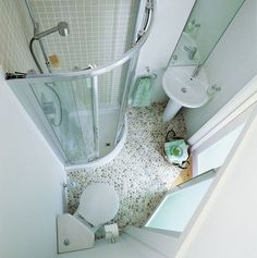 an aerial view of a bathroom with a toilet, sink and shower stall in it