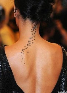 the back of a woman's neck with stars on it