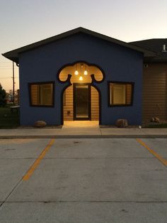 a blue building with yellow trim and windows