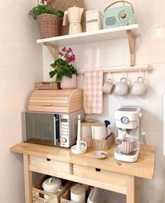 a kitchen counter with coffee maker, toaster and other items on the top shelf