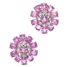 Oval sapphire and diamond cluster earrings. Clip post earrings with a hidden hook on the back to hang a pearl or other drop. 22 oval pink sapphires set in 18k white gold with 16 round accent diamonds. 22 oval bright medium pink Sapphires, well cut, approx. total weight 11.00cts, VS2 to SI1, natural color simple heat only, no other enhancements, GIA certificate #2155729732. 16 round full cut diamonds, approx. total weight .33cts, F-G, VS. Tested: 18k Stamped: 750 Hallmark: MXM 11.0 grams Top to bottom: 20.14mm or .79 inches Width: 18.36mm or .72 inches Depth: 7.5mm White Diamond Earrings, Diamond Cluster Earrings, Diamond Dangle Earrings, White Gold Earrings, Vintage Clip, Antique Earrings, Cluster Earrings, Gorgeous Jewelry, Diamond Cluster