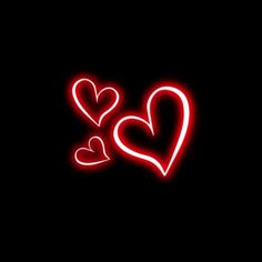 two red hearts on a black background with the word love written below it in neon lights