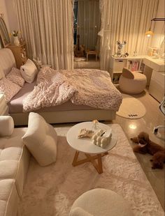 a bedroom with white furniture and lots of pillows on the bed, along with two teddy bears