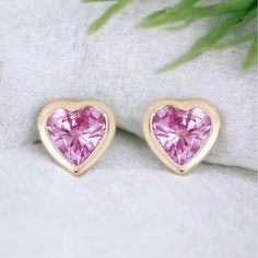 These elegant bezel-set heart-shaped Natural Pink Sapphire studs are subtle and will add color to any outfit you wear. DESCRIPTIONS FOR A PAIR OF STUDS: *Metal: 14K Yellow Gold *Metal Finish: High Shine Polish *Setting: Bezel-set *Gem Stones: Natural Sapphires *Color: Pink  *Shape: Heart-shaped *Stone Count: 2 PCS *Weight: 0.40cts T.W  *Backing Type: PushBack *Measurements: Approx. 4.8mm *Sold as a single stud or a pair. ------------------------------------- Beautiful Earring Box included Yellow Gold Double Heart Earrings For Valentine's Day, Valentine's Day Fine Jewelry Heart Earrings, Pink Fine Jewelry Heart Earrings As Gift, Heart Earrings For Valentine's Day Anniversary, Pink Heart Earrings Fine Jewelry For Gifts, Pink Round Earrings For Valentine's Day, Valentine's Day Heart Earrings For Anniversary, Yellow Gold Round Heart Earrings For Valentine's Day, Fine Jewelry Double Heart Earrings For Valentine's Day