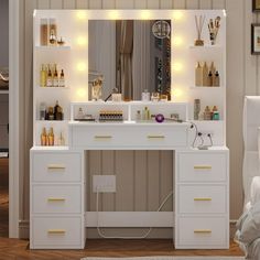 a white vanity with lights on it in a bedroom