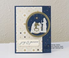 a christmas card with a nativity scene on the front and an ornament at the bottom