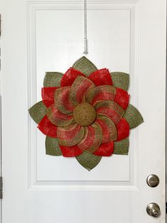 a white door with a red and green flower on it