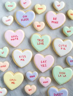 cookies with conversation hearts on them are arranged in the shape of heart - shaped biscuits