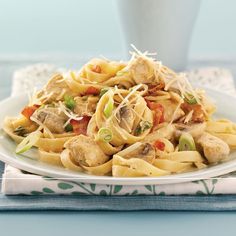 a white plate topped with pasta and meat