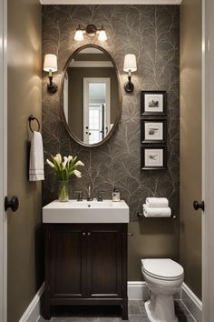 a bathroom with a toilet, sink and mirror in it's centerpieces