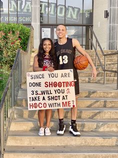 a man and woman standing on steps holding signs that read, since you are done shooting 3s will you take a shot at hoco with me?