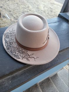 Camel colored felt hat with daisy design burned into it. Brown Felt Hat For Spring Rodeo, Brown Felt Hat For Rodeo In Spring, Spring Rodeo Brown Felt Hat, Spring Country Style Brimmed Felt Hat, Brown Flat Crown Felt Hat For Spring, Beige Felt Hat For Country Events In Spring, Brown Felt Hat With Short Brim For Spring, Brown Felt Hat For Spring Country Events, Brown Short Brim Felt Hat For Spring