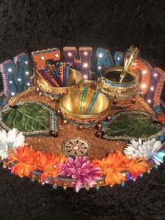 an elaborately decorated tray with candles and decorations