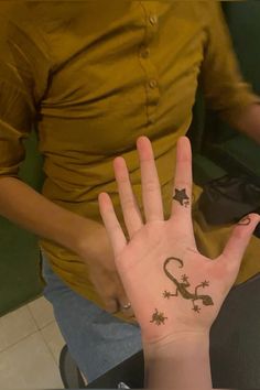 a person's hand with the number two on it and stars painted on it