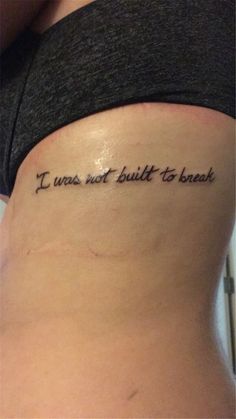 a woman with a tattoo on her stomach saying i was not built to banish