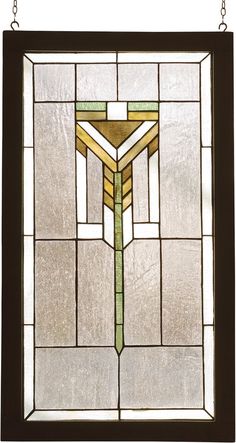 a stained glass window hanging from a chain on a white wall with a cross in the center