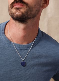 Utterly obsessing over this beautiful Genuine Blue Lapis Lazuli Shield Shaped pendant necklace. The stone has a 925 Sterling Silver Bezel around it. The back of the pendant also shows the stone. The pendant hangs from a 925 Sterling Silver 2mm wide Cuban Chain and has a lobster clasp Gemstone Size: 19mm x 19mm Chain: 925 Sterling Silver, 2mm wide, lobster clasp. Available in 20, 22, 24 and 26 inches. Other lengths available upon request. Made in the USA. Blue Sterling Silver Necklace With Polished Finish, Blue Pendant Necklace With Sterling Silver Clasp, Sapphire Pendant Necklace With Polished Finish, Lapis Lazuli Jewelry With Sterling Silver Clasp As Gift, Stainless Bracelet, Lapis Lazuli Pendant, Blue Lapis Lazuli, Blue Lapis, Gemstone Necklace Pendant