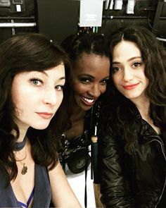 three women are posing for the camera together